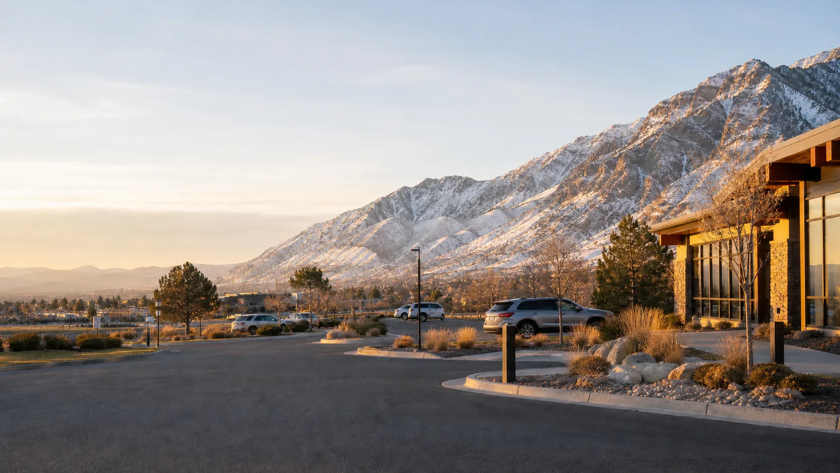 An orderly Utah Valley property arrival beneath the snow-dusted Wasatch Range at sunrise